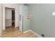 Spacious laundry room featuring wood-look flooring and beadboard paneling at 165 Dawn Rd, Benson, NC 27504
