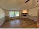 Open living room with wood-look flooring, electric fireplace, and natural lighting at 165 Dawn Rd, Benson, NC 27504