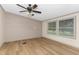 Inviting living room with wood-look floors, a ceiling fan, and bright natural light at 165 Dawn Rd, Benson, NC 27504