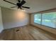 This bright living room has wood-look floors and two large windows at 165 Dawn Rd, Benson, NC 27504