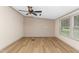 Well-lit living room featuring wood-look flooring, neutral walls, and a ceiling fan at 165 Dawn Rd, Benson, NC 27504