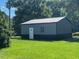 New metal outbuilding on green grassy lot, perfect for storage and outdoor activities at 165 Dawn Rd, Benson, NC 27504
