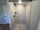 Shower with tile surround, shower head, and integrated shelves at 165 Dawn Rd, Benson, NC 27504
