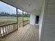 Relaxing back porch with wooden flooring, white trim and scenic views of the outdoors at 168 Clayton Rd, Princeton, NC 27569
