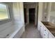 Unfinished bathroom featuring white soaking tub, drywall installed and a doorway to the side at 168 Clayton Rd, Princeton, NC 27569