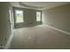 Bedroom featuring a tray ceiling, ample natural light, and an exterior door at 168 Clayton Rd, Princeton, NC 27569