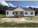 Newly constructed single story home boasts a covered front porch, white siding, and a modern design at 168 Clayton Rd, Princeton, NC 27569