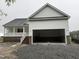 New home featuring a spacious two-car garage with carriage doors and traditional architecture at 168 Clayton Rd, Princeton, NC 27569