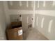 Unfinished laundry room with stubbed electrical, plumbing and a box of components at 168 Clayton Rd, Princeton, NC 27569