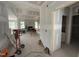 Open-concept living room with fireplace and large windows, under construction with drywall installed at 168 Clayton Rd, Princeton, NC 27569