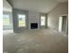 Bright living room features a cozy fireplace, vaulted ceiling, and large windows providing natural light at 168 Clayton Rd, Princeton, NC 27569