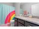 Colorful bathroom with a granite countertop and a vibrant shower curtain at 174 Walking Path Pl, Hillsborough, NC 27278