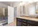 Modern bathroom with double sinks, granite countertops, and a tiled walk-in shower at 174 Walking Path Pl, Hillsborough, NC 27278