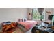 Cozy bedroom featuring a full-size bed, hardwood floors, and a view of the trees at 174 Walking Path Pl, Hillsborough, NC 27278