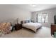Bright bedroom with a queen-size bed, neutral carpet and plenty of natural light at 174 Walking Path Pl, Hillsborough, NC 27278