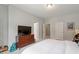 Spacious bedroom with a large TV, neutral walls, and ample closet space at 174 Walking Path Pl, Hillsborough, NC 27278