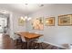 Dining room featuring a wooden table, modern chandelier, and stylish decor at 174 Walking Path Pl, Hillsborough, NC 27278