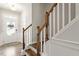 Bright entryway features wood floors and a staircase with white risers and wood railing at 174 Walking Path Pl, Hillsborough, NC 27278