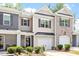 Townhome showcasing mixed facade, neat lawn, and welcoming front entrance at 174 Walking Path Pl, Hillsborough, NC 27278