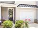 Inviting front entrance with black front door, garage, and manicured landscaping at 174 Walking Path Pl, Hillsborough, NC 27278