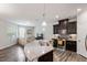 Open-concept kitchen with a large island and seamless flow to the living area at 174 Walking Path Pl, Hillsborough, NC 27278