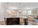 Bright kitchen island with granite counters is perfect for entertaining and meal prep at 174 Walking Path Pl, Hillsborough, NC 27278