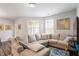 Comfortable living room with a large sectional sofa, bright windows, and a blue patterned rug at 174 Walking Path Pl, Hillsborough, NC 27278