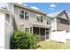 View of the back exterior of the home, featuring neutral siding and a screened porch at 174 Walking Path Pl, Hillsborough, NC 27278