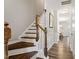 Elegant staircase with wood treads and white risers leads to the upper level at 174 Walking Path Pl, Hillsborough, NC 27278