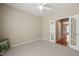 Bedroom with neutral carpet, ceiling fan, and french doors at 204 Dowington Ln, Cary, NC 27519