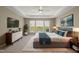 Stylish main bedroom featuring tray ceiling, plush carpet, and abundant natural light at 204 Dowington Ln, Cary, NC 27519
