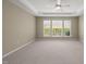 Bedroom boasts neutral carpet, tray ceiling, and large windows for ample natural light at 204 Dowington Ln, Cary, NC 27519