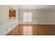 Dining room with hardwood floors, ample natural light, and view into kitchen at 204 Dowington Ln, Cary, NC 27519