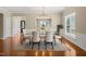 The dining room has a glass table, six chairs, a rug, and hardwood floors at 204 Dowington Ln, Cary, NC 27519