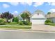 Charming home features a two-car garage, manicured landscaping and a combination of stone and siding exterior at 204 Dowington Ln, Cary, NC 27519