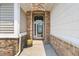 Close-up of the entryway featuring stone archway, pot, and stylish front door at 204 Dowington Ln, Cary, NC 27519