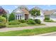 Charming home showcasing stone accents, manicured landscaping, and inviting curb appeal at 204 Dowington Ln, Cary, NC 27519