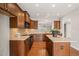 This kitchen features wood cabinets, hardwood floors, a center island, and recessed lighting at 204 Dowington Ln, Cary, NC 27519