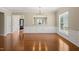 Bright living room boasts hardwood floors, and a large window with natural light at 204 Dowington Ln, Cary, NC 27519