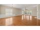 Bright living room featuring hardwood floors, large windows, and elegant chandelier at 204 Dowington Ln, Cary, NC 27519