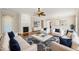 An open living room boasts hardwood flooring, a fireplace, neutral decor, and modern furnishings at 204 Dowington Ln, Cary, NC 27519