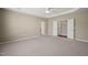 Large bedroom featuring neutral carpet, tray ceiling, closet and ensuite bath access at 204 Dowington Ln, Cary, NC 27519