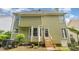 Back exterior view showing the green siding and backyard entrance with steps at 209 Woodstar Dr, Cary, NC 27513