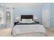 Stylish bedroom featuring a comfortable bed, side tables with lamps, and a serene light blue wall color at 209 Woodstar Dr, Cary, NC 27513