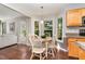 Bright breakfast nook bathed in natural light, featuring hardwood floors and access to outdoor space at 209 Woodstar Dr, Cary, NC 27513