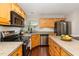Well-equipped kitchen featuring modern stainless appliances, granite countertops, and ample counter space at 209 Woodstar Dr, Cary, NC 27513