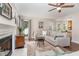 Inviting living area with hardwood floors, fireplace, and views to the dining area at 209 Woodstar Dr, Cary, NC 27513