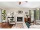 Cozy living room featuring a fireplace, ceiling fan, and comfortable seating arrangement at 209 Woodstar Dr, Cary, NC 27513