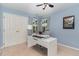 Bright home office with white desk, comfortable chair, and plenty of natural light at 209 Woodstar Dr, Cary, NC 27513