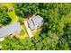 Aerial view of home with a long driveway and large back deck; property well-maintained and surrounded by trees at 2107 Somers Ave, Burlington, NC 27215